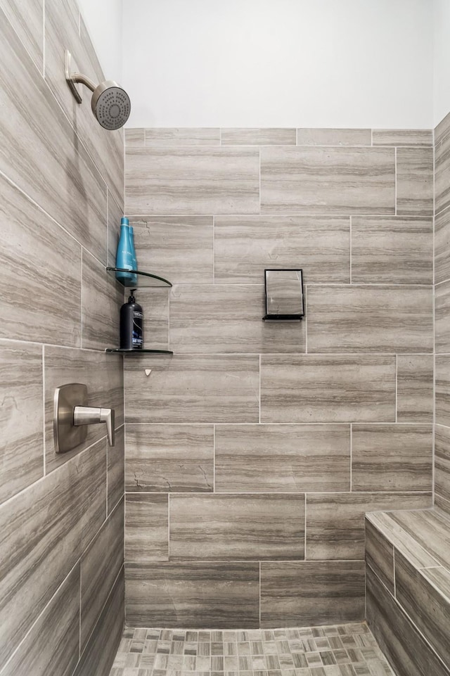 bathroom with tiled shower