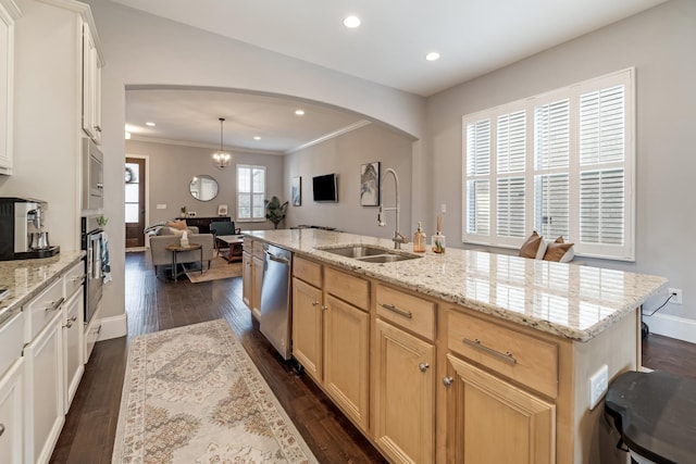 kitchen featuring stainless steel appliances, sink, hanging light fixtures, an island with sink, and a healthy amount of sunlight