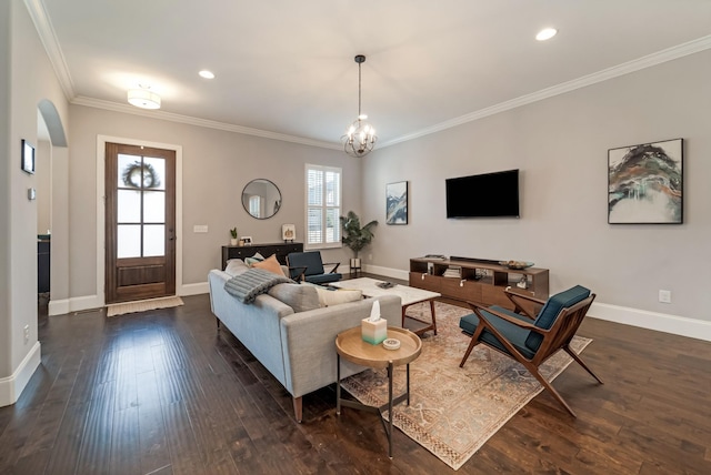 living room featuring crown molding, dark hardwood / wood-style flooring, and a notable chandelier