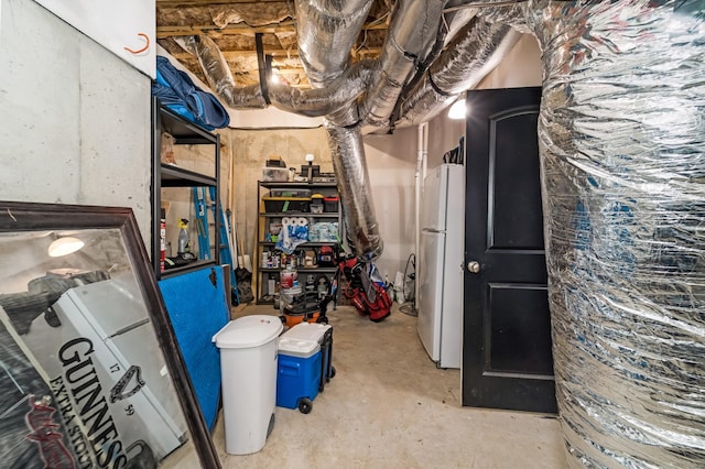 basement with white refrigerator