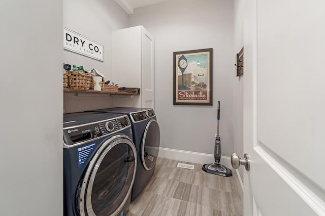 washroom featuring washing machine and clothes dryer