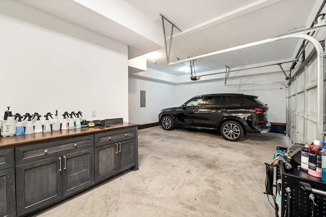 garage with a garage door opener and electric panel