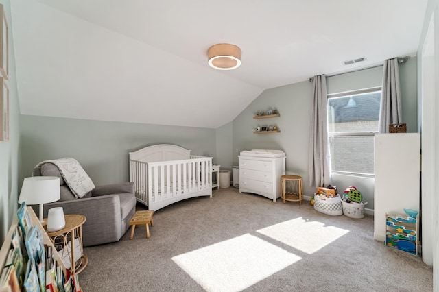 bedroom with carpet flooring, vaulted ceiling, and a crib