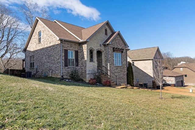 french country style house with a front yard and central air condition unit