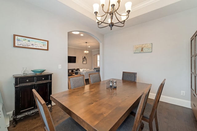 dining area with ornamental molding, dark hardwood / wood-style floors, and a notable chandelier