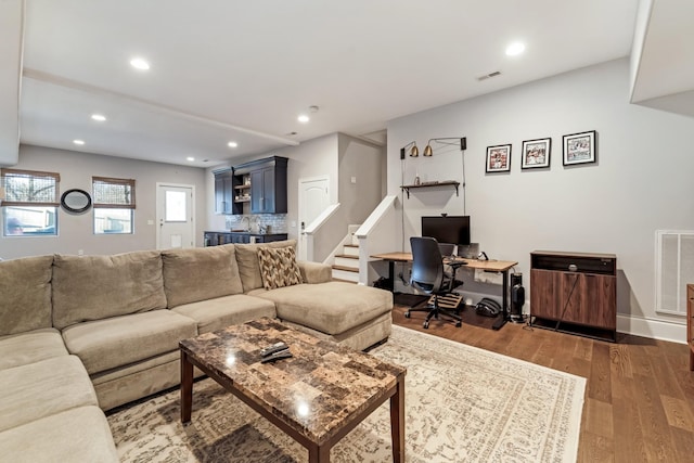 living room with wet bar and dark hardwood / wood-style floors