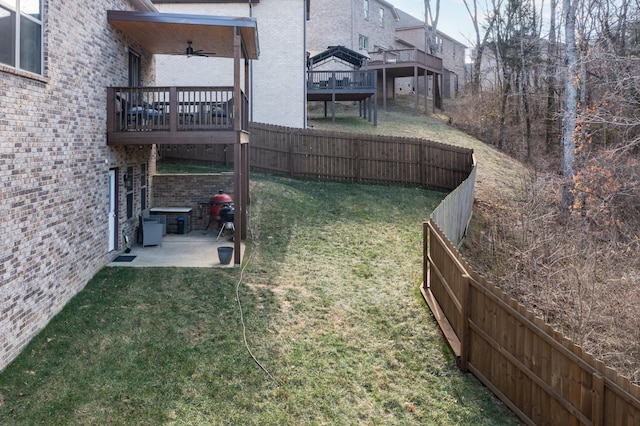 view of yard with a patio, a deck, and ceiling fan