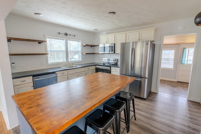 kitchen with wood counters, stainless steel appliances, and a center island