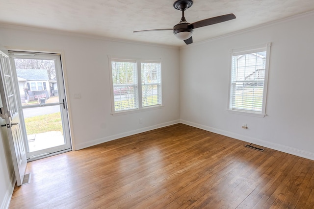 empty room featuring crown molding, ceiling fan, and light hardwood / wood-style floors