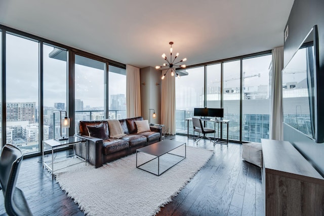 living room featuring dark hardwood / wood-style floors, a chandelier, and a wall of windows