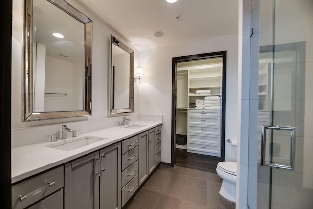 bathroom featuring vanity, toilet, and walk in shower