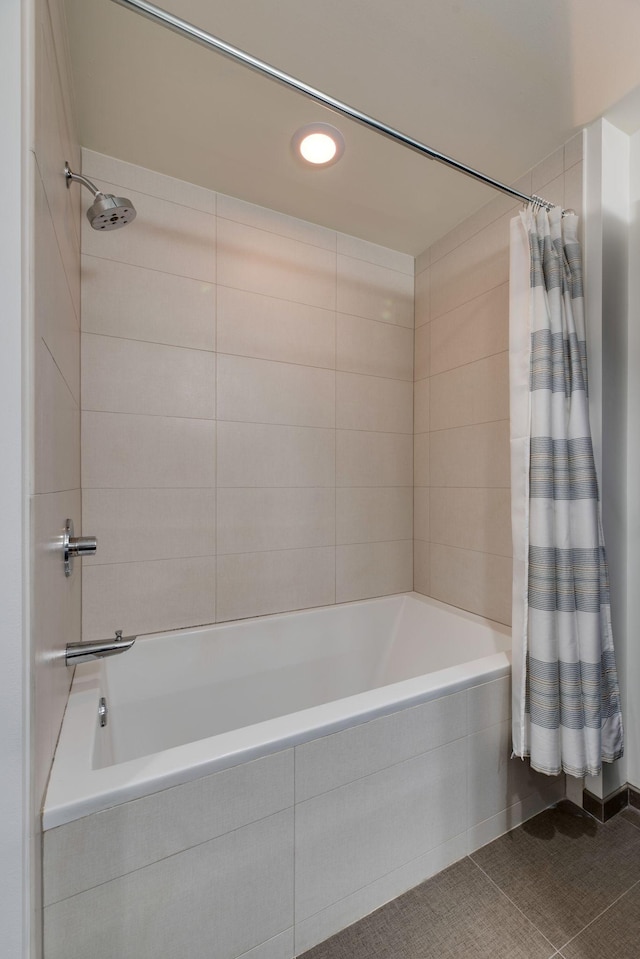 bathroom with shower / bathtub combination with curtain and tile patterned floors