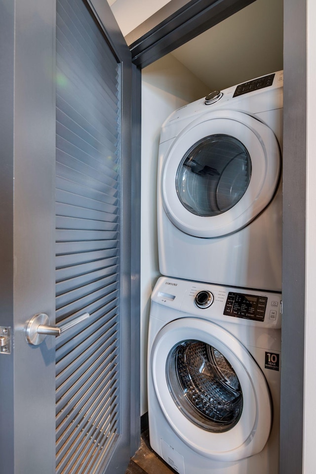 laundry area with stacked washer / drying machine