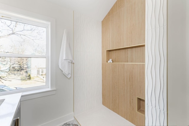 bathroom with lofted ceiling and a healthy amount of sunlight