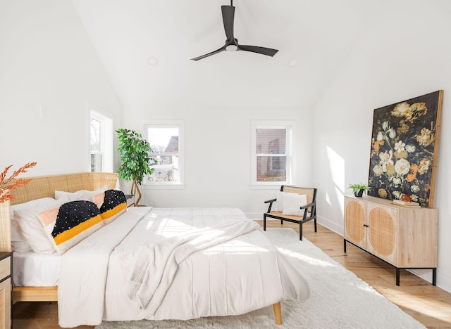 bedroom featuring ceiling fan, high vaulted ceiling, and light hardwood / wood-style floors