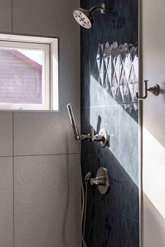 bathroom with tiled shower