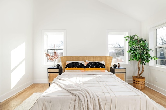 bedroom featuring lofted ceiling and light hardwood / wood-style flooring