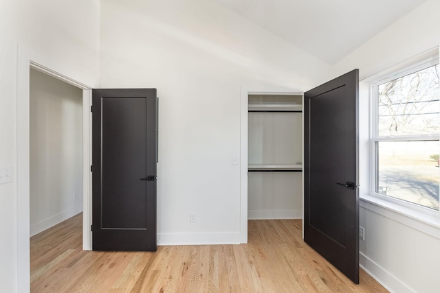 unfurnished bedroom with a closet and light wood-type flooring