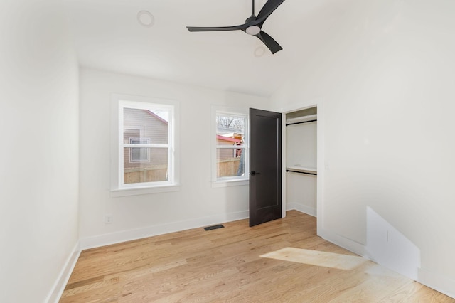 unfurnished bedroom with ceiling fan, lofted ceiling, and light hardwood / wood-style floors