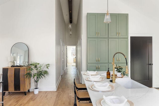 dining room featuring lofted ceiling, a wealth of natural light, and light wood-type flooring