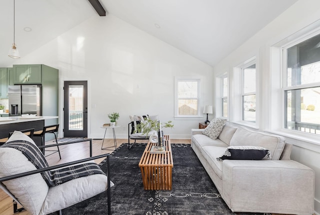 living room with dark hardwood / wood-style flooring and vaulted ceiling with beams