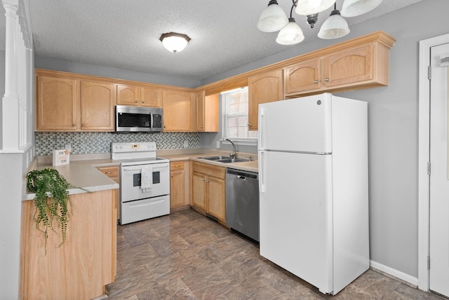 kitchen featuring stainless steel appliances, light brown cabinetry, a sink, and light countertops