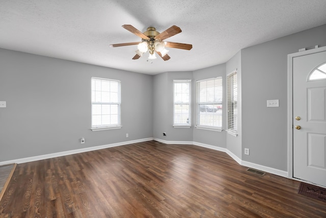 entryway featuring dark wood-style floors, a wealth of natural light, visible vents, and baseboards