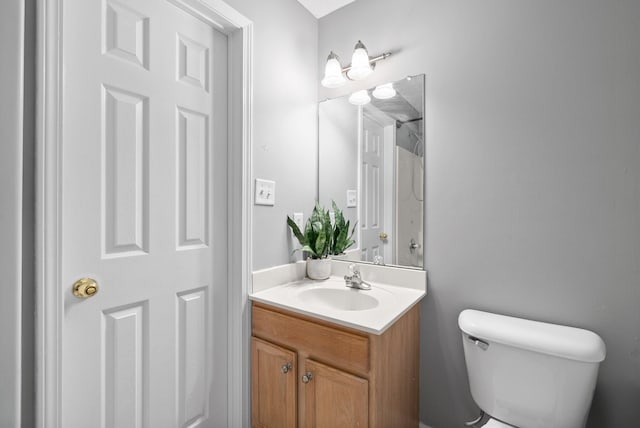 bathroom featuring toilet and vanity