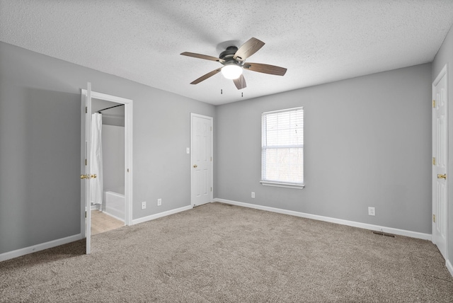 unfurnished bedroom with visible vents, carpet flooring, ceiling fan, a textured ceiling, and baseboards