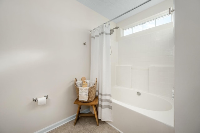 full bathroom featuring tile patterned flooring, shower / tub combo with curtain, and baseboards