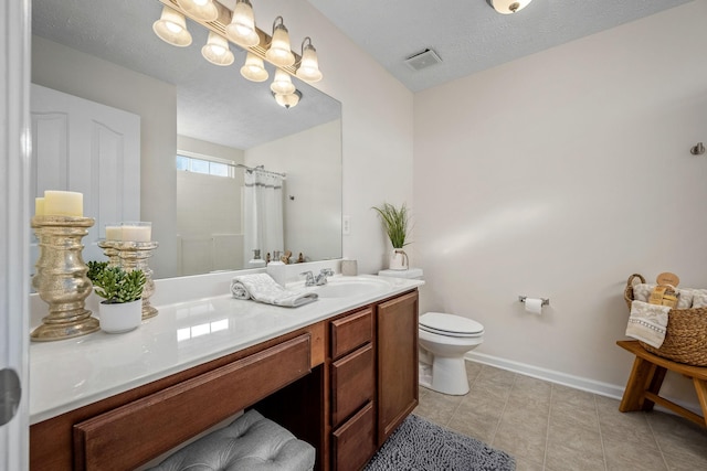 bathroom featuring tile patterned floors, toilet, a shower with curtain, a textured ceiling, and vanity