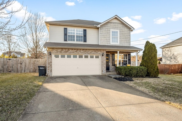 view of property featuring a garage, a porch, and a front yard