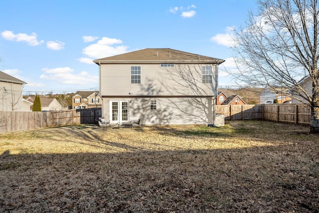 rear view of house with a yard