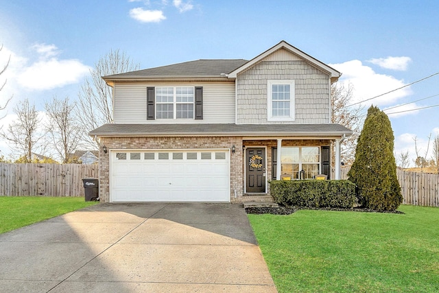 traditional home with fence, concrete driveway, an attached garage, a front yard, and brick siding