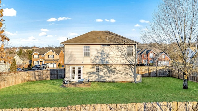 back of house with a lawn, french doors, and a fenced backyard