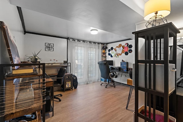 office area featuring hardwood / wood-style flooring and crown molding