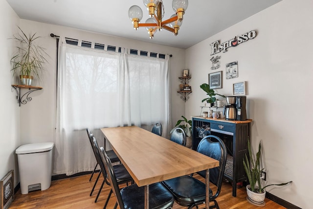 dining area featuring an inviting chandelier and wood-type flooring