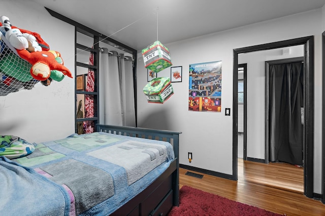 bedroom with wood-type flooring