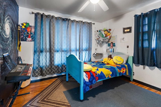 bedroom featuring dark hardwood / wood-style flooring and ceiling fan