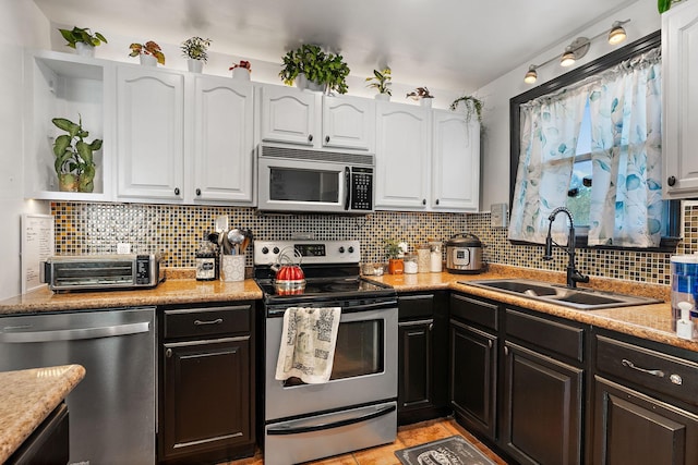 kitchen with white cabinetry, sink, tasteful backsplash, and stainless steel appliances