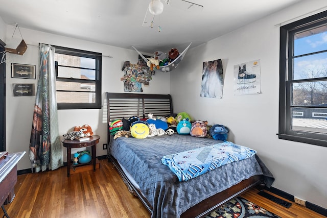 bedroom with wood-type flooring and ceiling fan