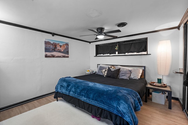 bedroom featuring crown molding, hardwood / wood-style floors, and ceiling fan