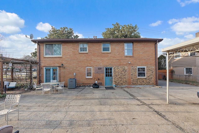 rear view of property featuring central AC and a patio area