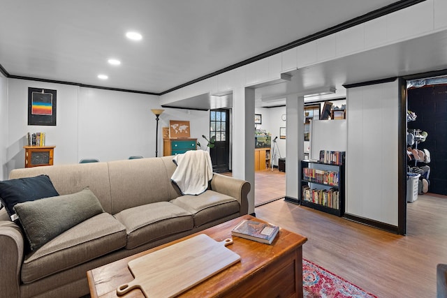 living room with ornamental molding and light wood-type flooring