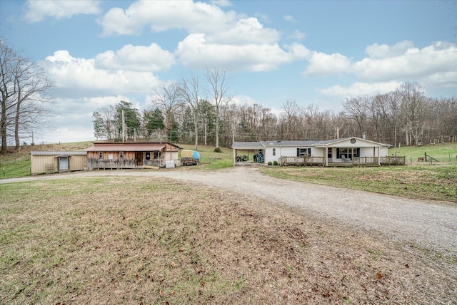 view of front of house featuring covered porch and a front lawn