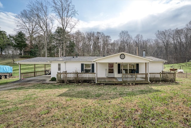 view of front of property with a front lawn, a carport, and a porch