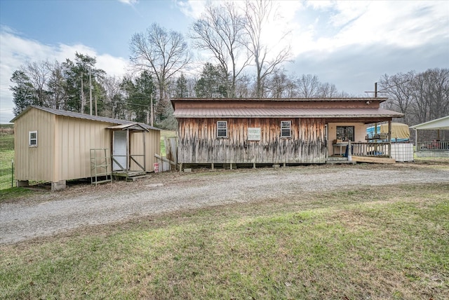 view of outbuilding featuring a yard and covered porch