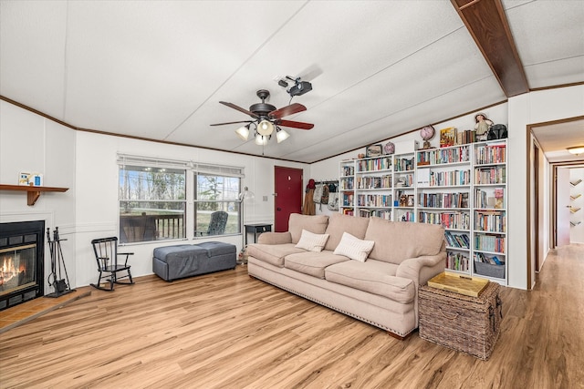 living room with lofted ceiling with beams, light hardwood / wood-style floors, and ceiling fan