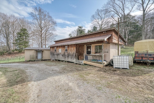 bungalow-style house with covered porch, a shed, and central air condition unit