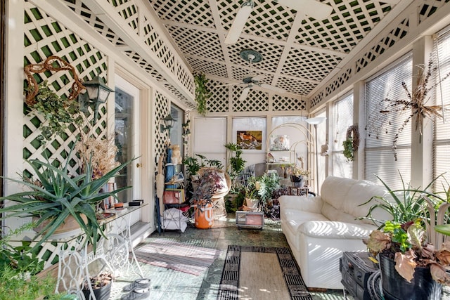 sunroom / solarium featuring ceiling fan